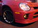 2005 Dodge SRT-4 - Front view of a red 2005 Dodge SRT-4, highlighting its distinctive bumper and wheel design.