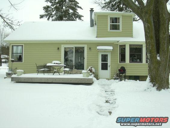 House with snow-covered deck and yard