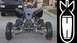 1999 Yamaha WARRIOR - An ATV is parked on a street with a truck in the background.