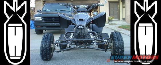 Black ATV parked in front of a black pickup truck