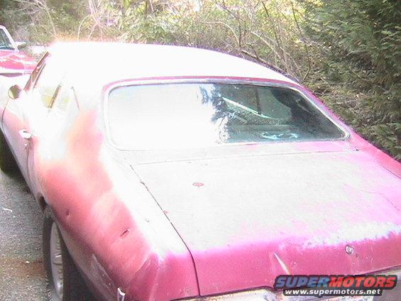 1968 Pontiac Lemans, pink, dented rear quarter panel, parked outdoors