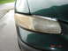 1997 Dodge Grand Caravan - Close-up of a discolored and damaged minivan headlight.