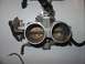 1988 Ford Bronco - This is a close-up view of a vehicle's throttle body assembly, showing two butterfly valves.