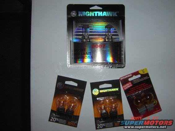 Four packages of automotive light bulbs: GE Nighthawk 9007, two GE Nighthawk 3057, and Sylvania 3157LL