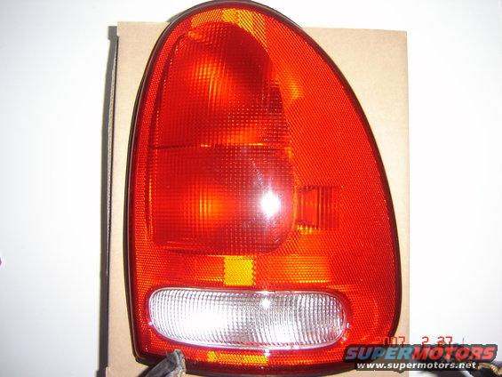 Red plastic tail light assembly with clear reverse light section