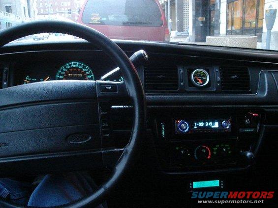 1992 Ford Crown Victoria interior dashboard with glowing gauges and aftermarket radio