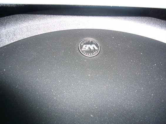 Close-up of a JL Audio subwoofer grille with a "W6" logo