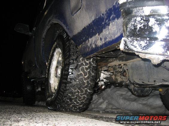 1993 Ford Bronco side view, blue, with snow on tires and ground