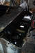 1968 Ford Mustang - The interior floor pan of a vehicle is shown during a repair process, with the steering wheel visible.