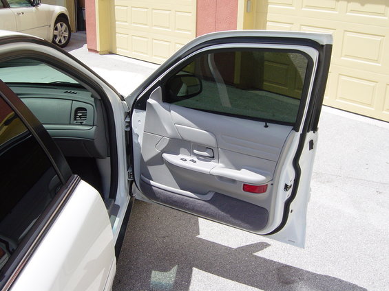 White 2000 Ford Crown Victoria interior door panel and dashboard