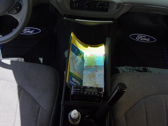 Car interior showing Ford floor mats, a map of Florida, and a radio
