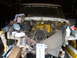 1978 Ford Bronco - The engine bay of a vehicle is shown with extensive wiring and components exposed, suggesting a repair or modification is in progress.