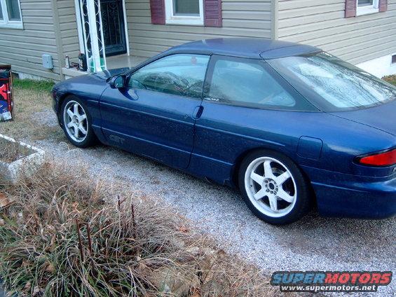 Blue 1994 Ford Probe GT parked on gravel in front of a house