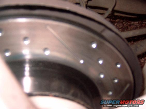 Slotted and drilled brake rotor with Supermotors logo