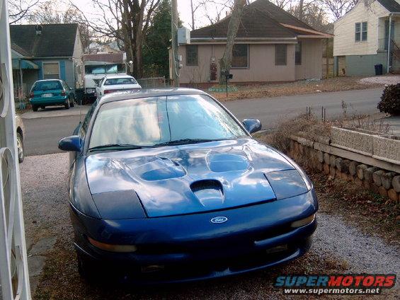 Blue Ford Probe with hood scoops, parked in a driveway