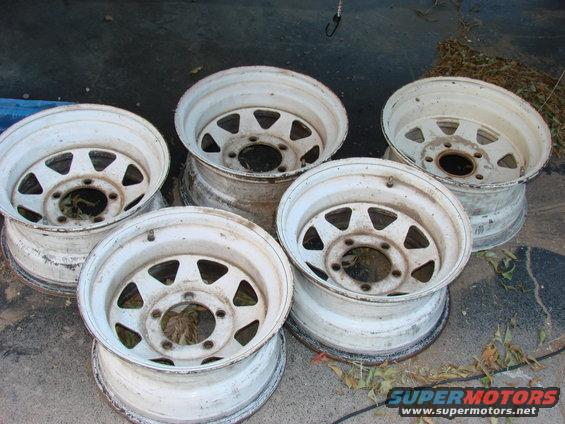 five white steel wheels with triangular cutouts