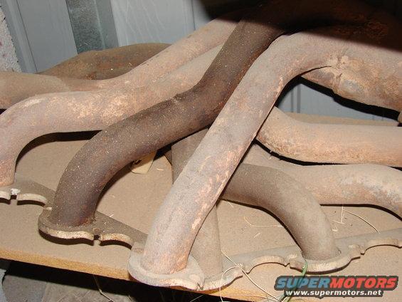pile of rusty exhaust manifolds