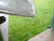 1997 Dodge Grand Caravan - Water is dripping from a metal object onto a grassy area.
