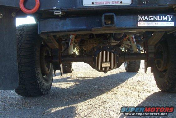 Rear axle and suspension of a truck with a MAGNUM V sticker and a license plate that says SESQUICENTENNIAL - 150 YEARS