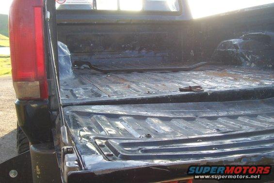 1994 Ford F-150 truck bed with tailgate down, showing the ribbed metal floor and side walls