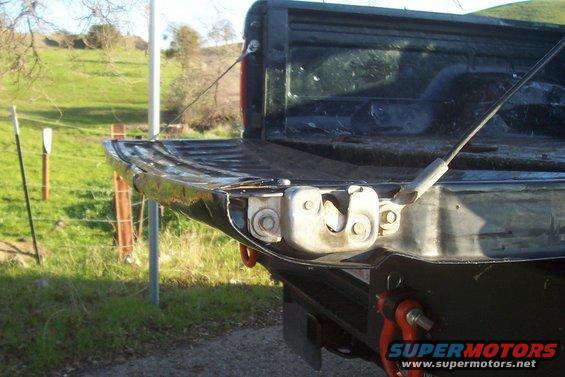 Black Ford F-150 tailgate latch mechanism, rear view, showing wear and tear