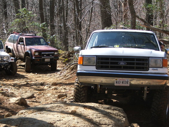 White 1996 Ford Bronco front view on rocky terrain