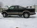 1994 Ford Probe - This black pickup truck with tan trim is parked on a snowy surface.
