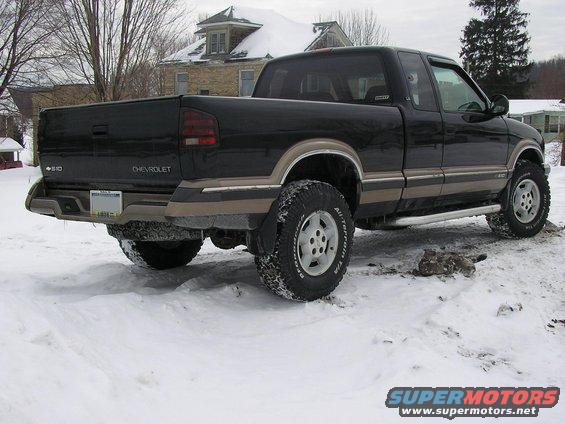 Black Chevrolet S-10 pickup truck rear view in snow