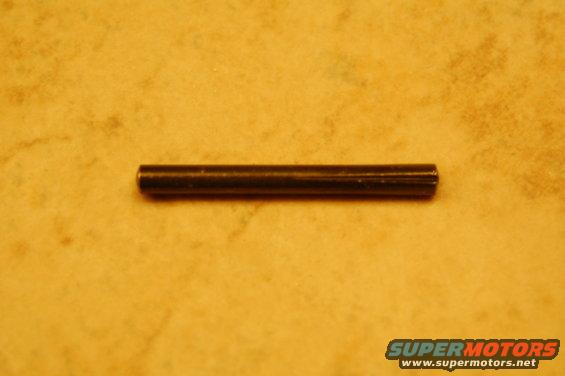 metal pin on textured surface, supermotors.net logo at bottom right