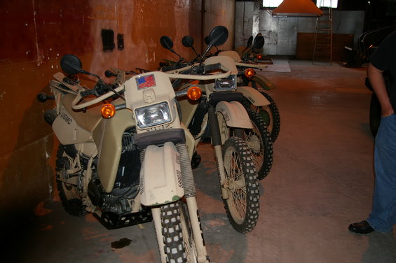 Front view of tan military motorcycles with USMC markings