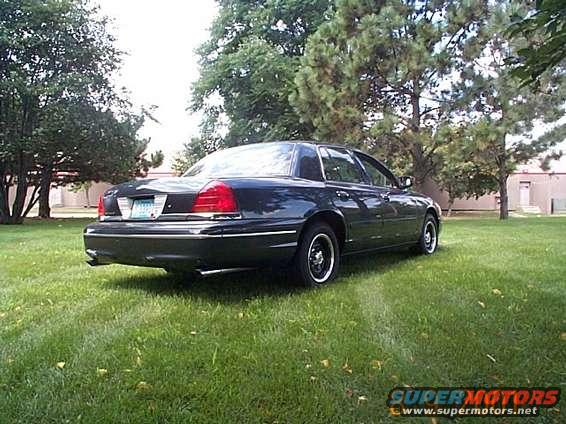 1998 Ford Crown Victoria parked on grass, rear view