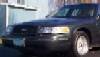 Front view of dark sedan with grille and headlights visible