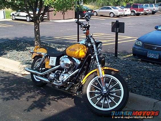 Yellow motorcycle parked on asphalt