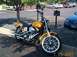 1998 Ford Crown Victoria - A yellow motorcycle is parked in a lot with other vehicles visible in the background.
