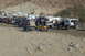 1995 Ford Bronco - A group of off-road vehicles and RVs are gathered in a desert landscape.