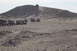 1995 Ford Bronco - A group of Jeeps navigates a challenging off-road course on a steep, rocky incline.