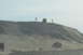 1995 Ford Bronco - Several people stand on a hill overlooking two vehicles in a sandy, outdoor environment.