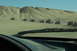 1995 Ford Bronco - A convoy of off-road vehicles navigates a sandy desert terrain.