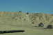 1995 Ford Bronco - Multiple off-road vehicles navigate a steep, sandy incline on a sunny day.