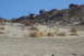 1995 Ford Bronco - Multiple off-road vehicles navigate a challenging sandy incline in a desert landscape.