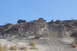 1995 Ford Bronco - Multiple off-road vehicles navigate a steep, sandy incline on a clear day.