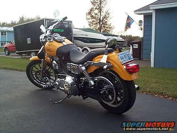 Yellow motorcycle rear view with license plate 44-870