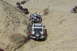 1995 Ford Bronco - A group of off-road vehicles and a motorcycle descend a challenging desert trail.