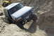 1995 Ford Bronco - This 1995 Ford Bronco is shown tackling a challenging off-road trail, with another vehicle visible behind it.