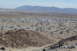 1995 Ford Bronco - A large gathering of RVs and off-road vehicles are spread across a desert landscape.