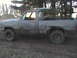 1980 Dodge Magnum - This 1980 Dodge Magnum pickup truck is covered in mud, showing significant rust on the rear fender.