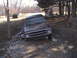 1980 Dodge Magnum - A brown Dodge Ramcharger is stuck in a muddy, debris-strewn area with trees in the background.