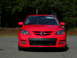 2007 Mazda 3 - The front grille and headlights of a red Mazda 3 are visible.
