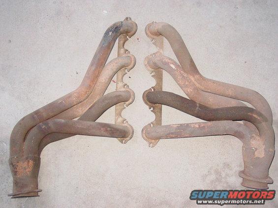 Pair of rusty exhaust manifolds, likely for a V8 engine