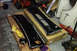 1968 Ford Mustang - Two black car body panels and yellow gloves are laid out on cardboard boxes in a garage setting.